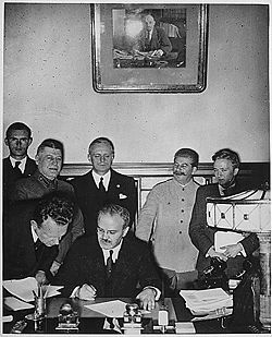 Molotov 
signing the Nazi-Soviet Pact - to his right Stalin and next Ribbentrop