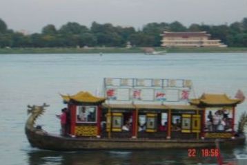 Pleasure boat with a dragon head on the bow on the Yalu River, North Korea in the background